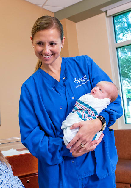 Baptist Labor & Delivery Nurse with baby